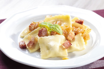 Portion of ravioli with onion and bacon