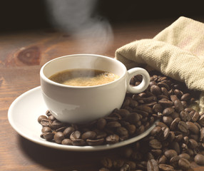 coffee cup and grains on wooden table