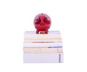 Red piggy bank on books
