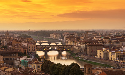 Naklejka na ściany i meble Sunset view of Ponte Vecchio over Arno River in Florence, Italy
