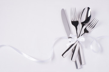 Glossy silverware on white background