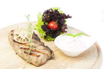 Catfish steak cooking on a grill in the restaurant