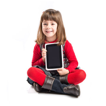 Cute little girl playing with tablet over white