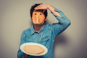 Man with pancake on his face - obrazy, fototapety, plakaty