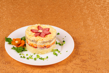 Fresh salad with mayonnaise, sausage, potatoes, pepper