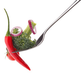Fresh raw vegetables on fork isolated on white background cutout