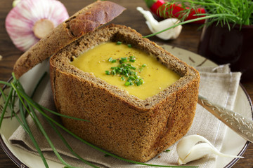 Fototapeta na wymiar Lentil soup in the bowl of bread.