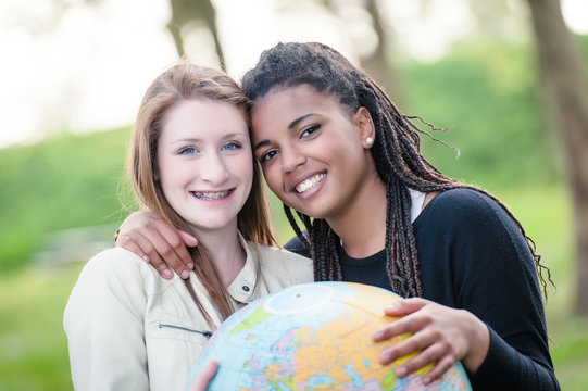 Multiracial Couple of friends Holding Globe Map