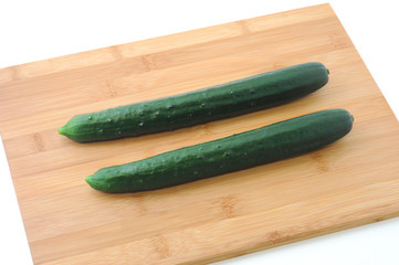 2 cucumbers isolated on cutting board