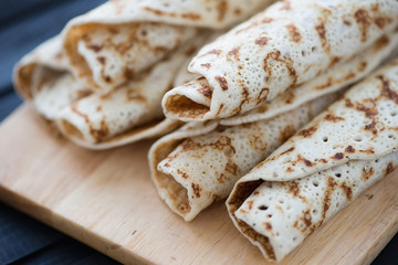 Close-up of rolled homemade pancakes, horizontal shot