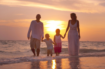 Family having fun on vacation with perfect sunset