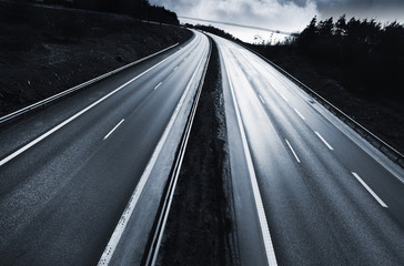 highway in evening light, storm clouds at the horizon