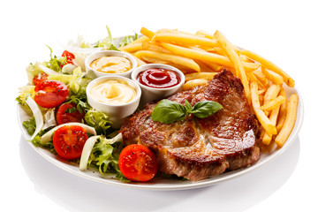 Grilled steak, French fries and vegetables