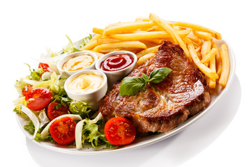 Grilled steak, French fries and vegetables