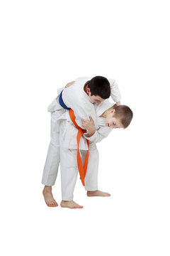 Capture for throw is performing athlete  with orange belt