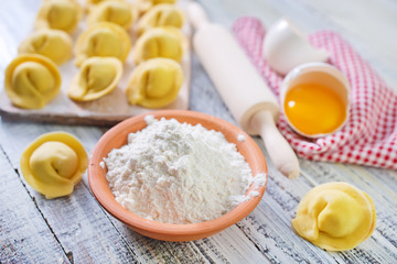 flour and raw pelmeni