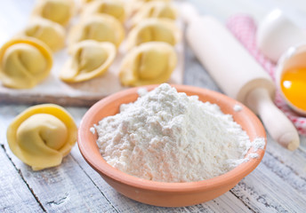 flour and raw pelmeni