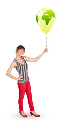 Happy lady holding a green globe balloon