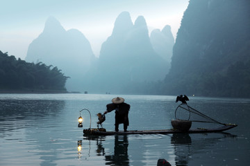 Chinese man fishing with cormorants birds, traditional fishing u