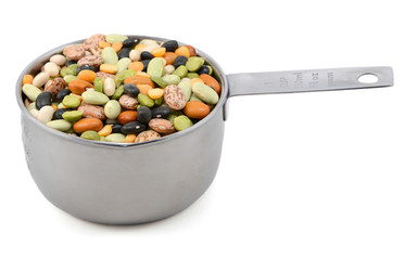 Mixed dried beans in a metal cup measure