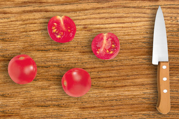knife and slices of tomato on cutting board isolated on white