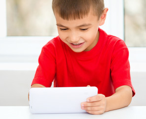 Young boy is using tablet