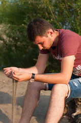 The young man smiles close up