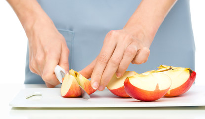 Obraz na płótnie Canvas Cook is chopping apple