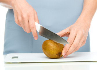 Cook is chopping kiwifruit