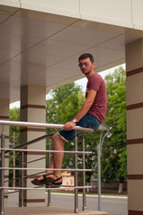 The young man smiles close up