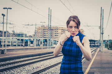 Pretty girl ready to fight along the tracks