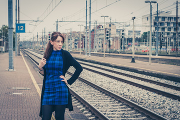 Pretty girl posing along the tracks