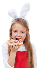 Little girl with bunny ears eating a sandwich