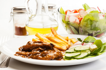 Pork chop with sauce, mushrooms and chips