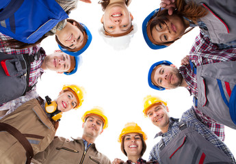 Construction workers standing in circle