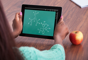 Student Solving Chemistry Problem At Classroom