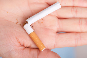 Addiction. Broken cigarette on hand. Quit smoking