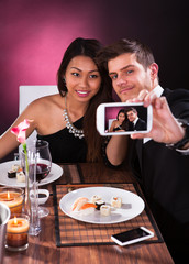 Couple Taking Self Portrait At Restaurant