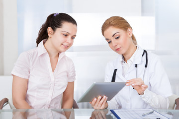 Fototapeta premium Doctor And Patient Looking At Laptop