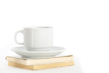 Composition with books and cup of coffee isolated on white
