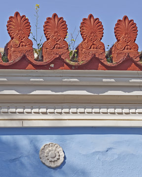yellow flower on vintage roof antefix
