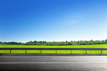 road and field of spring grass