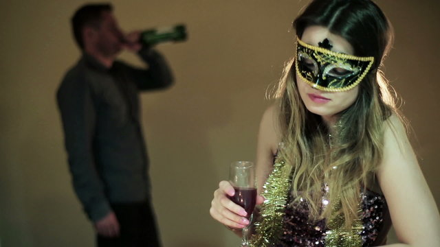 drunk woman in a mask with a glass of wine  and a drunk man in t