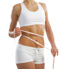 young athletic woman measuring waist