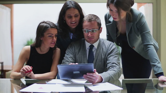 Businesspeople working together on tablet in the office, steadyc