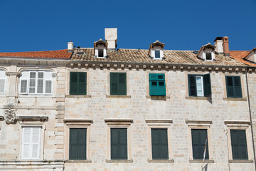 Fototapeta na wymiar Old Croatian Building with Green Shutters