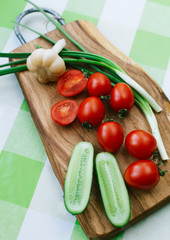 tomatoes and green onions on cutting board