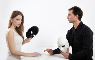 Man and woman taking off their masks