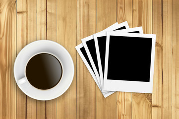 Cup of coffee and old photo paper on wooden background