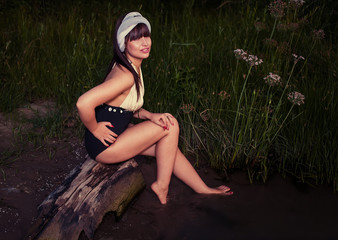 Retro looking  women sitting on driftwood